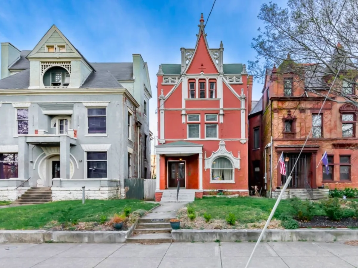 Victorian homes with steep gabled roofs along a street in Old Louisville