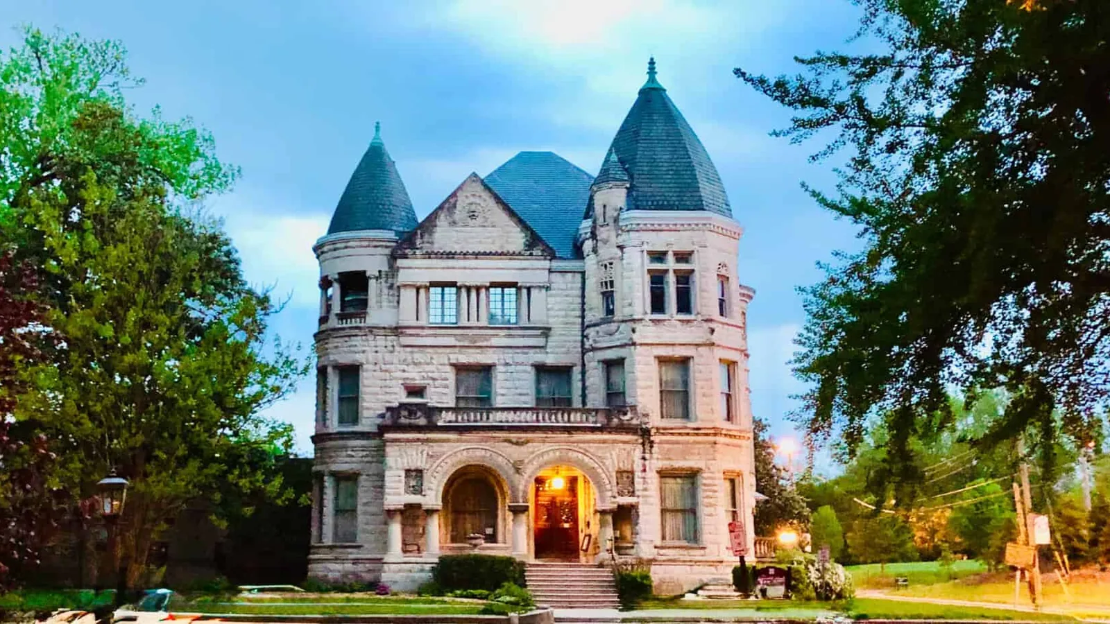 Historic stone mansion with turrets and a steep roof in Old Louisville