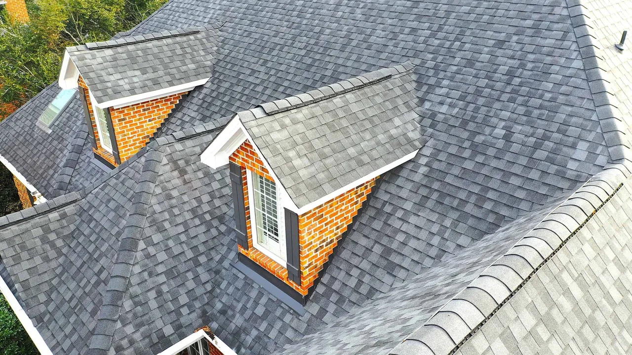 Aerial view of a new architectural shingle roof with dormers on a home after a roof replacement