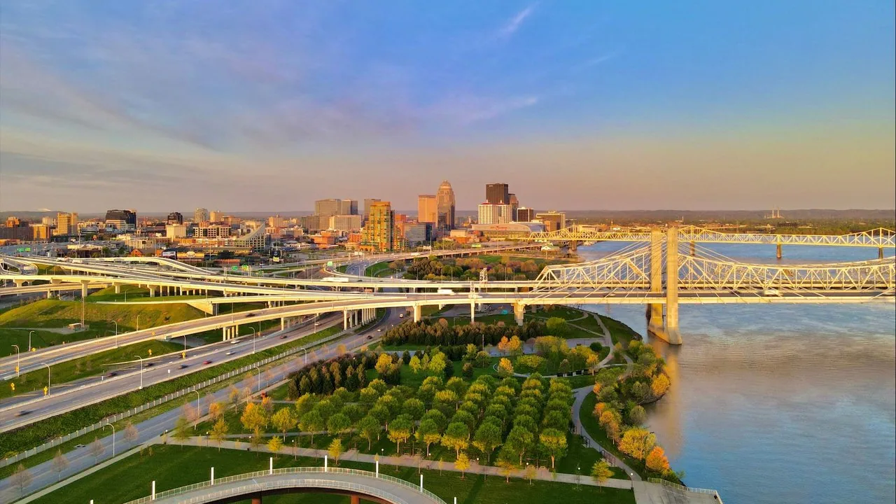 The Louisville skyline and Ohio River bridges above the riverfront park